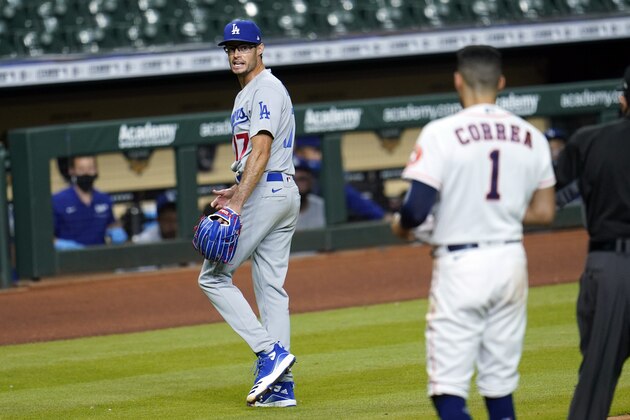 Los Angeles Dodgers relief pitcher Joe Kelly (17) yells back at Houston Astros' Carlos Correa (1) after the sixth inning of a baseball game Tuesday, July 28, 2020, in Houston. Both benches emptied during the exchange. (AP Photo/David J. Phillip)