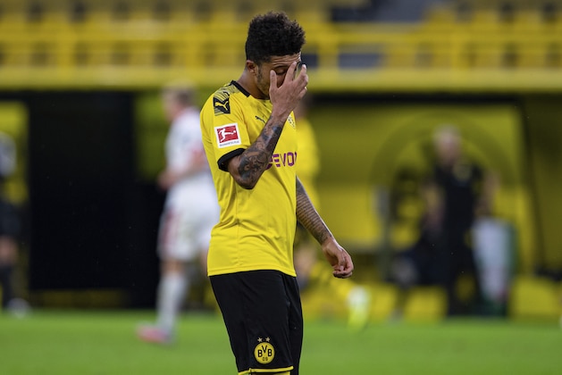 Dortmund's Jadon Sancho walks on the pitch during the German Bundesliga soccer match between Borussia Dortmund and 1. FSV Mainz 05 in Dortmund, Germany, Wednesday, June 17, 2020. (Guido Kirchner/DPA via AP, Pool)