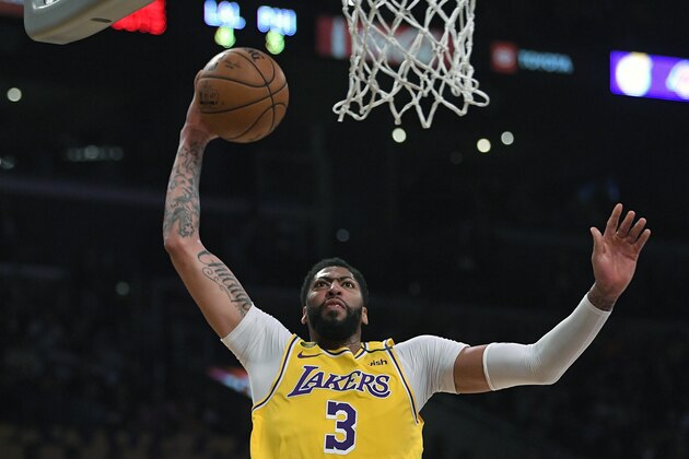 FILE - In this Tuesday, March 3, 2020, file photo, Los Angeles Lakers forward Anthony Davis shoots during the first half of an NBA basketball game against the Philadelphia 76ers in Los Angeles. Davis left his team’s scrimmage against the Orlando Magic on Saturday, July 25, 2020, after being poked in the right eye and is listed as day-to-day. (AP Photo/Mark J. Terrill, File) FILE - In this Tuesday, March 3, 2020, file photo, Los Angeles Lakers forward Anthony Davis shoots during the first half of an NBA basketball game against the Philadelphia 76ers in Los Angeles. Davis left his team’s scrimmage against the Orlando Magic on Saturday, July 25, 2020, after being poked in the right eye and is listed as day-to-day. (AP Photo/Mark J. Terrill, File)