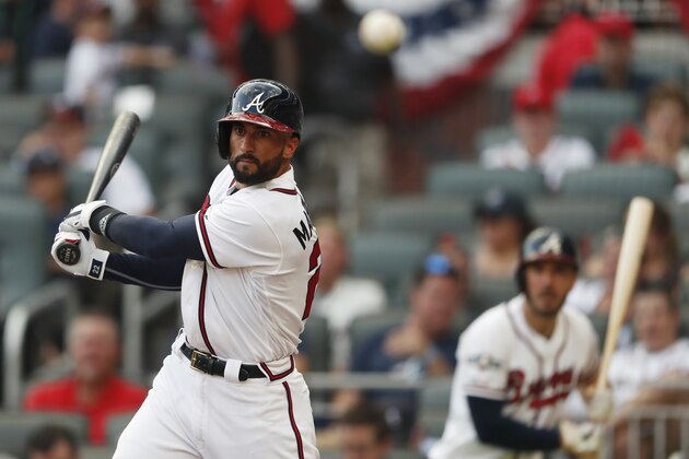 Atlanta Braves right fielder Nick Markakis (22) hits a foul tip against the St. Louis Cardinals in the fourth inning during Game 1 of a best-of-five National League Division Series, Thursday, Oct. 3, 2019, in Atlanta. (AP Photo/John Bazemore)