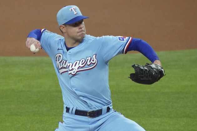 Texas Rangers starting pitcher Corey Kluber pitches against the Colorado Rockies in the first inning of a baseball game Sunday, July 26, 2020, in Arlington, Texas. (AP Photo/Louis DeLuca)