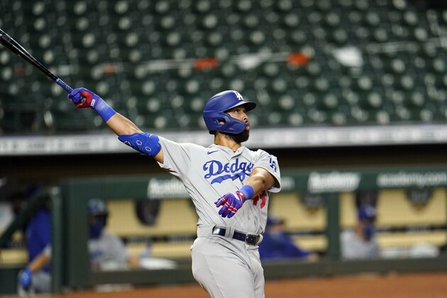Los Angeles Dodgers' Edwin Rios watches his two-run home run against the Houston Astros during the 13th inning of a baseball game Wednesday, July 29, 2020, in Houston. (AP Photo/David J. Phillip)
