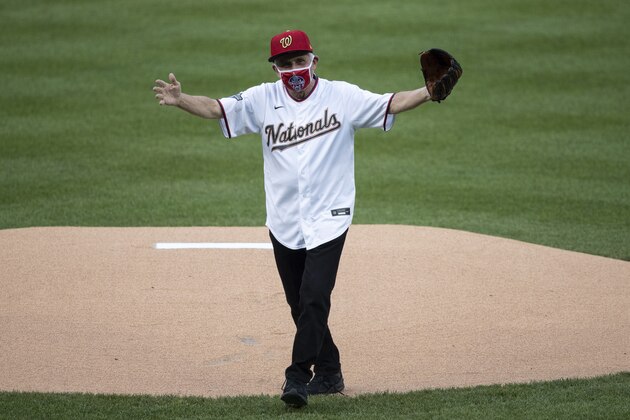 Dr. Anthony Fauci, director of the National Institute of Allergy and Infectious Diseases, reacts after throwing out a ceremonial first pitch before an opening day baseball game between the Washington Nationals and the New York Yankees at Nationals Park, Thursday, July 23, 2020, in Washington. (AP Photo/Alex Brandon)