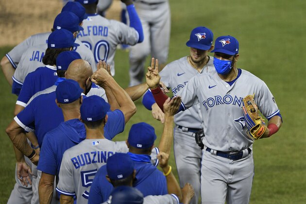 Toronto Blue Jays left fielder Lourdes Gurriel Jr., right front, and teammates celebrate after a baseball game against the Washington Nationals, Tuesday, July 28, 2020, in Washington. The Blue Jays won 5-1. (AP Photo/Nick Wass)