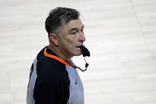 FILE - In this July 25, 2020, file photo, official Michael Price uses a covered whistle during the second half of a WNBA basketball game between the Washington Mystics and Indiana Fever in Bradenton, Fla. In the pro sports restart, referees are covering their whistles with baggies to prevent spittle from escaping during the coronavirus pandemic. (AP Photo/Phelan M. Ebenhack, File)