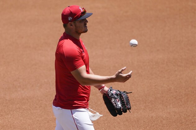 Los Angeles Angels center fielder Mike Trout tosses a ball during baseball practice at Angel Stadium on Wednesday, July 8, 2020, in Anaheim, Calif. (AP Photo/Ashley Landis)