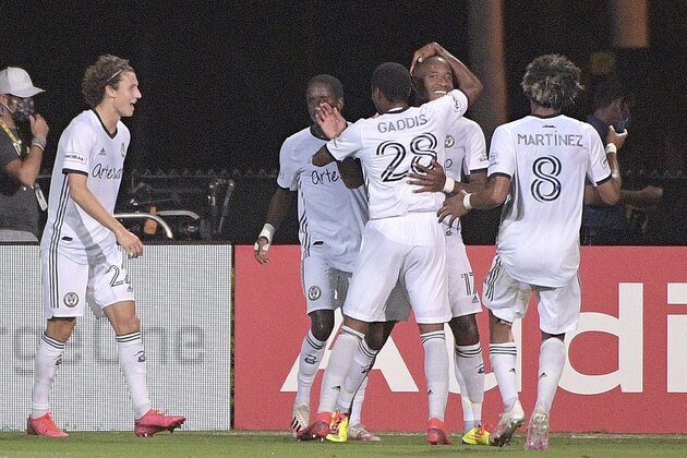 Philadelphia Union forward Sergio Santos (17) is congratulated by teammates after scoring a goal during the first half of an MLS soccer match against Sporting Kansas City, Thursday, July 30, 2020, in Kissimmee, Fla. (AP Photo/Phelan M. Ebenhack)