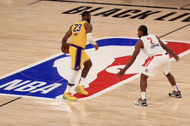 Los Angeles Lakers LeBron James (23) dribbles the ball against Los Angeles Clippers Kawhi Leonard (2) during the third quarter of an NBA basketball game Thursday, July 30, 2020, in Lake Buena Vista, Fla. (Mike Ehrmann/Pool Photo via AP)