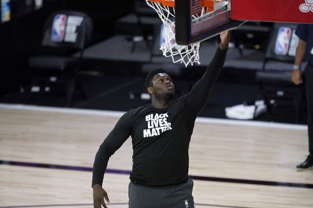 New Orleans Pelicans' Zion Williamson wears a Black Lives Matter shirt while warming up before the start of an NBA basketball game against the Utah Jazz Thursday, July 30, 2020, in Lake Buena Vista, Fla. (AP Photo/Ashley Landis, Pool)