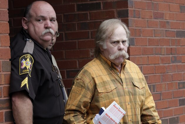 Harvey Updyke departs the Lee County Justice Center in Opelika, Ala., Monday, June 10, 2013. Updyke pleaded guilty in March to one count of unlawful damage of an animal or crop facility. He was sentenced to 6 months in jail and credited with 104 days for time already served. The oaks were removed in April. Under his probation, Updyke is forbidden from attending any collegiate sports event, will have a 7 p.m. curfew and is banned from Auburn University. (AP Photo/Dave Martin)