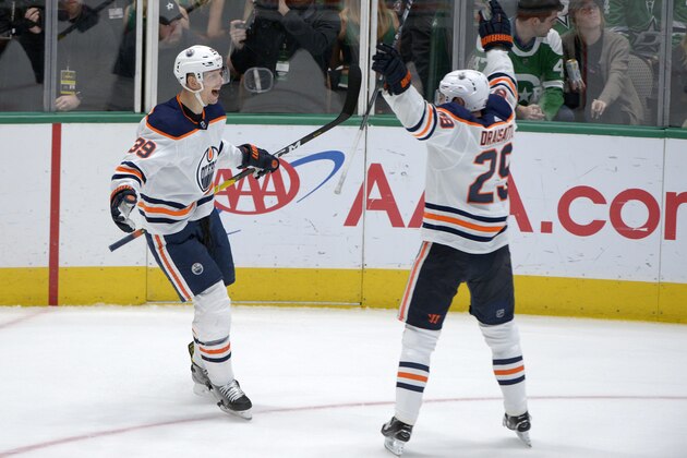 Edmonton Oilers right wing Alex Chiasson (39) and center Leon Draisaitl (29) celebrate Chiasson's overtime goal against the Dallas Stars in an NHL hockey game in Dallas, Tuesday, March 3, 2020. The Oilers won 2-1. (AP Photo/Matt Strasen)