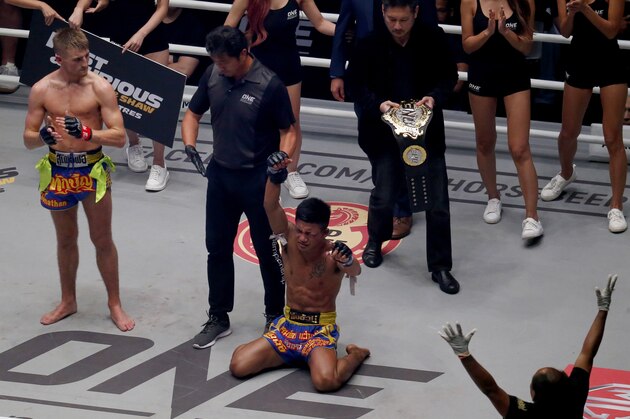 New ONE Flyweight Muay Thai World Champion Rodtang Jitmuangnon of Thailand falls to his knees after winning over Jonathan Haggerty, left, of the United Kingdom in their ONE Flyweight World Championship Mixed Martial Arts title fight dubbed 'Dawn of Heroes' Friday, Aug. 2, 2019 at the Mall of Asia Arena in suburban Pasay city south of Manila, Philippines. Rodtang dethroned Haggerty via a unanimous decision. (AP Photo/Bullit Marquez)