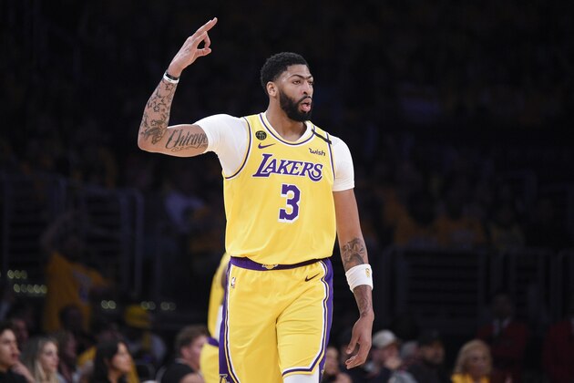 Los Angeles Lakers forward Anthony Davis reacts after a shot made by Kentavious Caldwell-Pope during the first half of an NBA basketball game against the Portland Trail Blazers in Los Angeles, Friday, Jan. 31, 2020. (AP Photo/Kelvin Kuo)