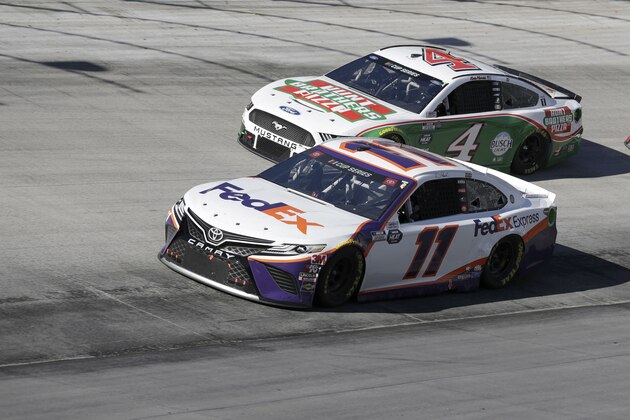 Denny Hamlin (11) drives followed by Kevin Harvick (4) during a NASCAR Cup Series auto race at Bristol Motor Speedway Sunday, May 31, 2020, in Bristol, Tenn. (AP Photo/Mark Humphrey)