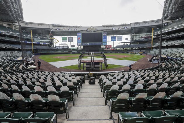 Fan cutouts are seen behind home plate at Miller Park after it was announced that the Milwaukee Brewers home opener was postponed after two St. Louis Cardinals employees tested positive for the coronavirus, Friday, July 31, 2020, in Milwaukee. (AP Photo/Morry Gash)