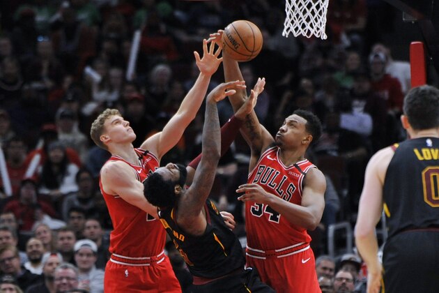 Cleveland Cavaliers' Andre Drummond (3) and Chicago Bulls' Wendell Carter Jr. (34) and Lauri Markkanen (24) vie for a rebound during the second half of an NBA basketball game Tuesday, March 10, 2020, in Chicago. (AP Photo/Paul Beaty)