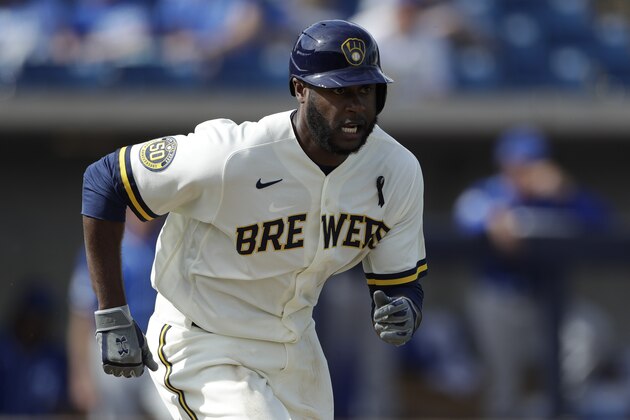 Milwaukee Brewers' Lorenzo Cain bats during the fifth inning of a spring training baseball game against the Kansas City Royals, Thursday, Feb. 27, 2020, in Phoenix. (AP Photo/Gregory Bull)