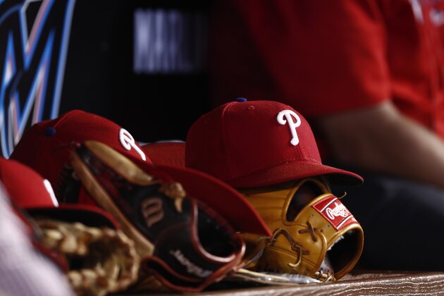 Philadelphia Phillies players hats and baseball gloves sit in the dugout during a baseball game against the Miami Marlins on Sunday, June 30, 2019, in Miami. (Brynn Anderson)