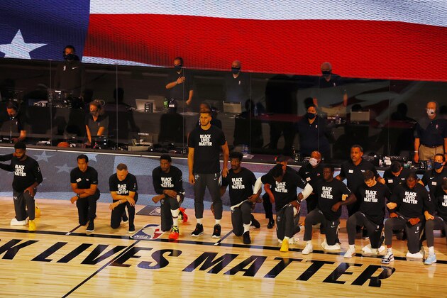 Miami Heat's Meyers Leonard stands during the national anthem before an NBA basketball game against the Denver Nuggets, Saturday, Aug. 1, 2020, in Lake Buena Vista, Fla. (Kevin C. Cox/Pool Photo via AP)