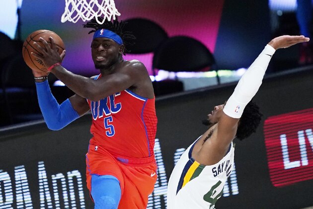 Oklahoma City Thunder's Luguentz Dort (5) drives around Utah Jazz's Donovan Mitchell during the second half of an NBA basketball game Saturday, Aug. 1, 2020, in Lake Buena Vista, Fla. (AP Photo/Ashley Landis, Pool)