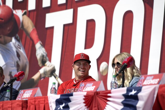 Los Angeles Angels owner Arte Moreno, left, sits with center fielder Mike Trout, center, and Jessica Trout during a news conference to talk about Trout's 12-year, $426.5 million contract, prior to the team's exhibition baseball game against the Los Angeles Dodgers on Sunday, March 24, 2019, in Anaheim, Calif. (AP Photo/Mark J. Terrill)