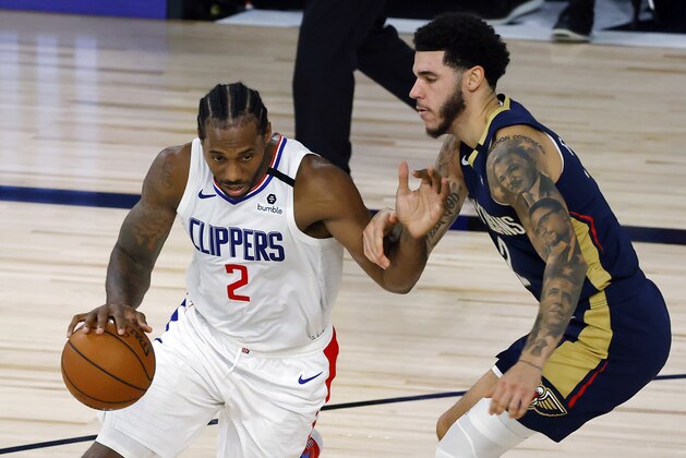 Los Angeles Clippers' Kawhi Leonard, left, drives against New Orleans Pelicans' Lonzo Ball, right, during an NBA basketball game Saturday, Aug. 1, 2020, in Lake Buena Vista, Fla. (Kevin C. Cox/Pool Photo via AP)