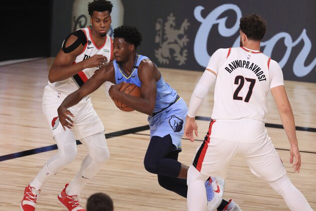 Memphis Grizzlies' Jaren Jackson Jr., center, drives to the basket during the first half of an NBA basketball game against the Portland Trail Blazers, Friday, July 31, 2020, in Lake Buena Vista, Fla. (Mike Ehrmann/Pool Photo via AP)
