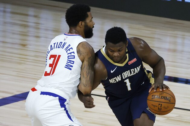 Los Angeles Clippers' Marcus Morris Sr., left, defends against New Orleans Pelicans' Zion Williamson during the first half of an NBA basketball game Saturday, Aug. 1, 2020, in Lake Buena Vista, Fla. (Kevin C. Cox/Pool Photo via AP)