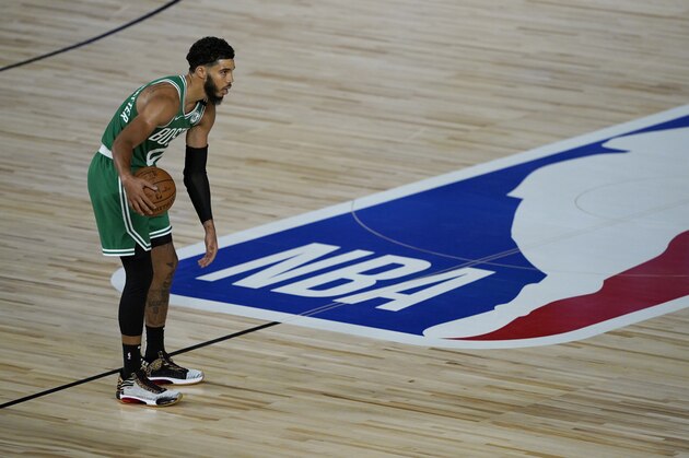 Boston Celtics' Jayson Tatum brings the ball down the court during the second half of an NBA basketball game against the Milwaukee Bucks Friday, July 31, 2020, in Lake Buena Vista, Fla. (AP Photo/Ashley Landis, Pool)