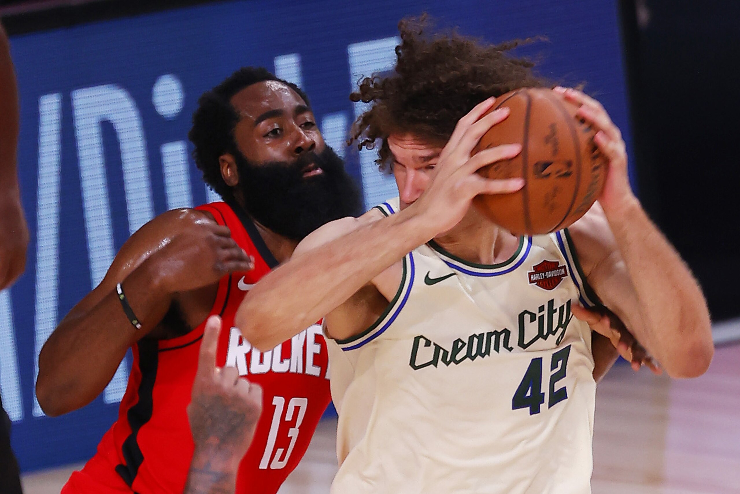 Milwaukee Bucks' Robin Lopez moves around Houston Rockets' James Harden during an NBA basketball game Sunday, Aug. 2, 2020, in Lake Buena Vista, Fla. (Mike Ehrmann/Pool Photo via AP)