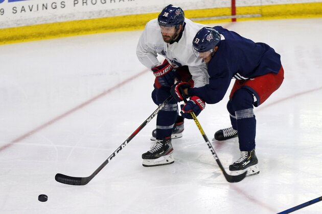 Columbus Blue Jackets' Boone Jenner, left, and Gabriel Carlsson, of Sweden, chase a loose puck during NHL hockey practice, Friday, July 24, 2020, in Columbus, Ohio. (AP Photo/Jay LaPrete)