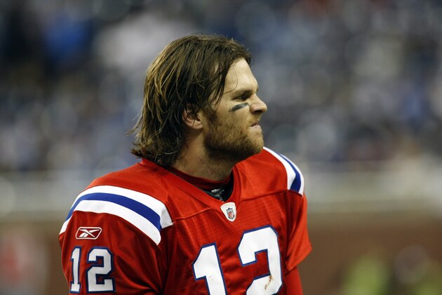 New England Patriots quarterback Tom Brady (12) watch game action with his hair out and wearing no helmet, on the sideline in the fourth quarter of an NFL football game with the Detroit Lions, Thursday, Nov. 25, 2010, in Detroit, Mich. New England won 45-24. (AP Photo/Tony Ding)
