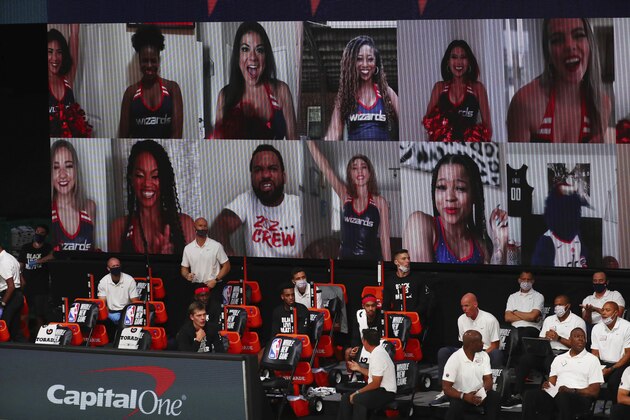 Virtual fans are displayed on a digital board in the first half of an NBA basketball game between the Washington Wizards and the Phoenix Suns in Lake Buena Vista, Fla., Friday, July 31, 2020. (Kim Klement/Pool Photo via AP)