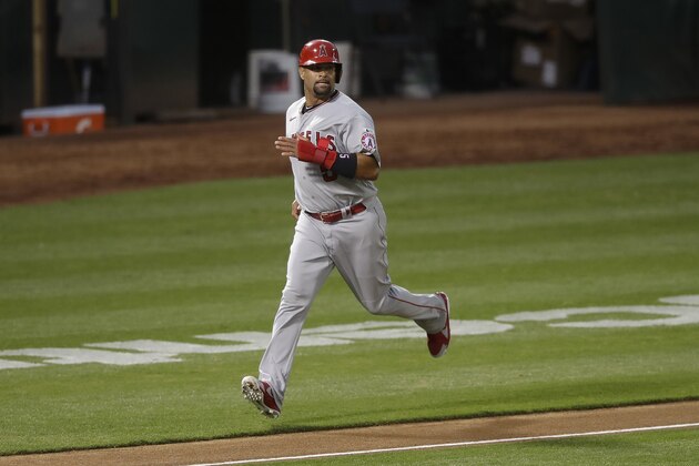 Los Angeles Angels' Albert Pujols runs home to score against the Oakland Athletics during the fourth inning of a baseball game in Oakland, Calif., Friday, July 24, 2020. (AP Photo/Jeff Chiu)