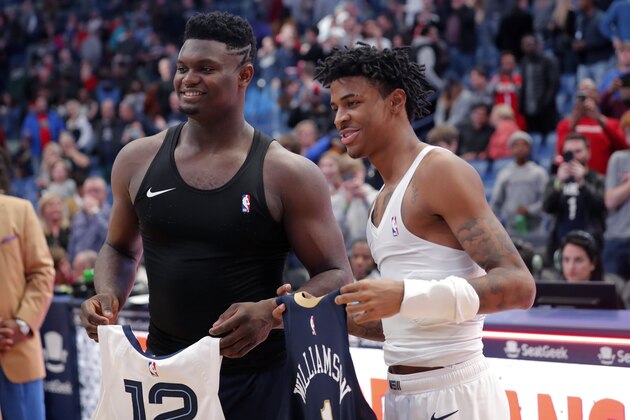 New Orleans Pelicans forward Zion Williamson, left, and Memphis Grizzlies guard Ja Morant exchange jerseys after an NBA basketball game in New Orleans, Friday, Jan. 31, 2020. The Pelicans won 139-111. (AP Photo/Gerald Herbert)