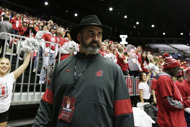 Washington State football head coach Nick Rolovich walks along the court before an NCAA college basketball game between Washington State and Oregon State in Pullman, Wash., Saturday, Jan. 18, 2020. (AP Photo/Young Kwak) Washington State football head coach Nick Rolovich walks along the court before an NCAA college basketball game between Washington State and Oregon State in Pullman, Wash., Saturday, Jan. 18, 2020. (AP Photo/Young Kwak)