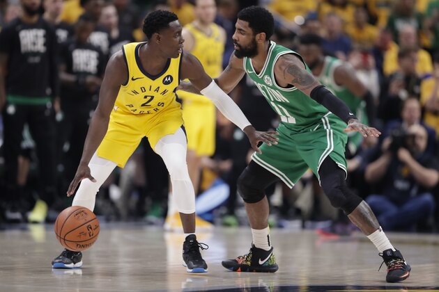 Boston Celtics guard Kyrie Irving (11) defends Indiana Pacers guard Darren Collison (2) during the first half of Game 4 of an NBA basketball first-round playoff series in Indianapolis, Sunday, April 21, 2019. (AP Photo/Michael Conroy)