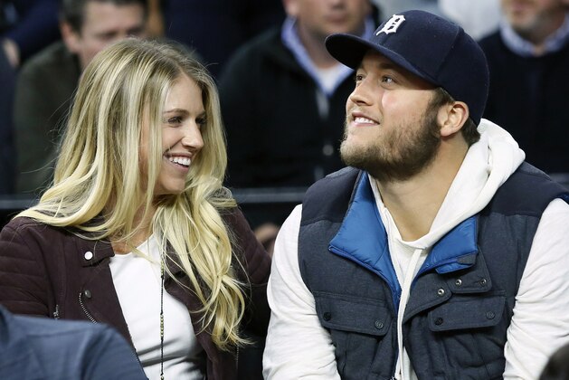 FILE - In this Nov. 17, 2015, file photo, Detroit Lions quarterback Matthew Stafford, right, smiles while watching the Detroit Pistons play the Cleveland Cavaliers with his wife Kelly, left, during the first half of an NBA basketball game, in Auburn Hills, Mich. Kelly Stafford says she is home after surgery to remove a brain tumor. She says the surgery lasted 12 hours and shared other details Sunday, April 21, 2019, on her Instagram account. (AP Photo/Duane Burleson, File)