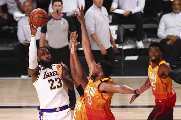 Los Angeles Lakers forward LeBron James (23) shoots over Utah Jazz center Tony Bradley (13) during the first half of an NBA basketball game Monday, Aug. 3, 2020, in Lake Buena Vista, Fla. (Kim Klement/Pool Photo via AP) Los Angeles Lakers forward LeBron James (23) shoots over Utah Jazz center Tony Bradley (13) during the first half of an NBA basketball game Monday, Aug. 3, 2020, in Lake Buena Vista, Fla. (Kim Klement/Pool Photo via AP)
