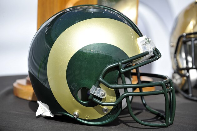 A Colorado State helmets sit next to the Rocky Mountain Showdown trophy before the start of an NCAA college football game Sunday, Sept. 1, 2013, in Denver. (AP Photo/Jack Dempsey)