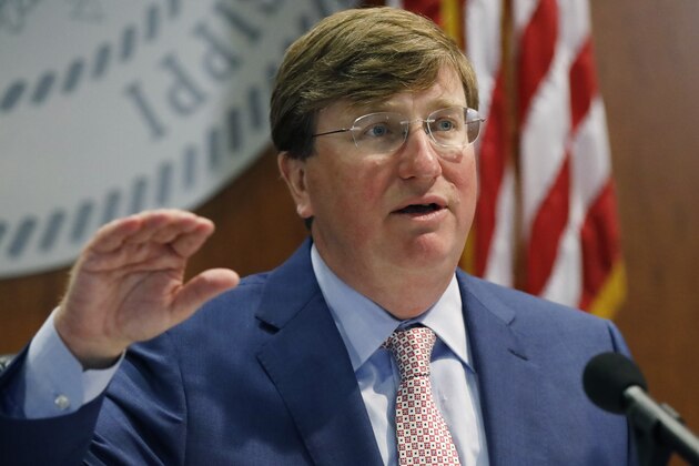 Gov. Tate Reeves discusses his statewide order for people to wear masks in public amid a recent surge in cases of the new coronavirus during a COVID-19 press briefing, Tuesday, Aug. 4, 2020 in Jackson, Miss. Director of the Mississippi Emergency Management Agency Greg Michel and State Health Officer Dr. Thomas Dobbs, also spoke and provided an update on the coronavirus and the state's ongoing strategy to limit transmission. (AP Photo/Rogelio V. Solis)