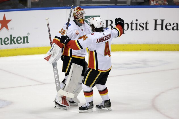 Calgary Flames defenseman Rasmus Andersson (4) celebrates with goaltender Cam Talbot after the Flames defeated the Florida Panthers 3-0 during an NHL hockey game, Sunday, March 1, 2020, in Sunrise, Fla. (AP Photo/Wilfredo Lee)