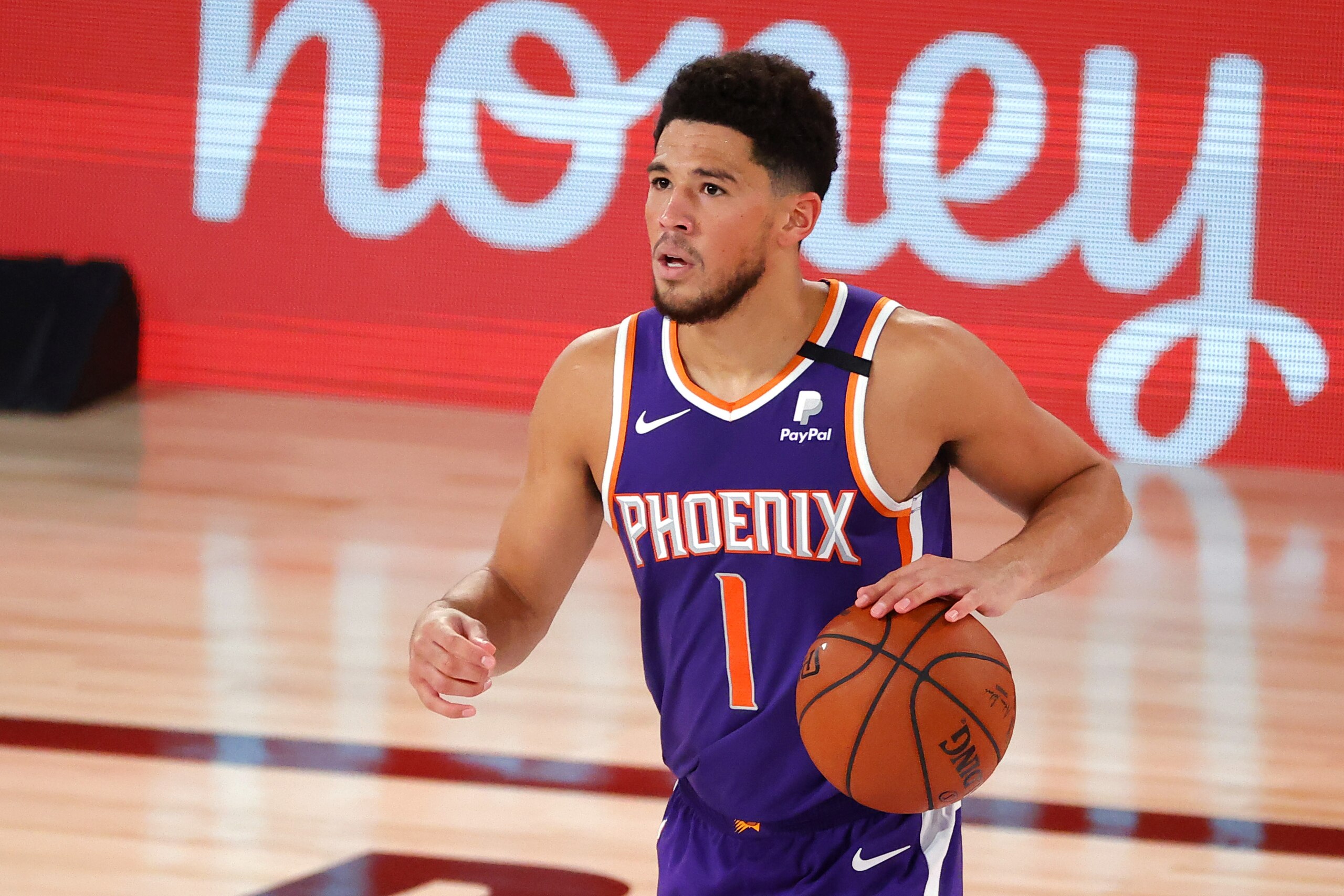 Phoenix Suns' Devin Booker dribbles against the Los Angeles Clippers during an NBA basketball game Tuesday, Aug. 4, 2020, in Lake Buena Vista, Fla. (Kevin C. Cox/Pool Photo via AP)