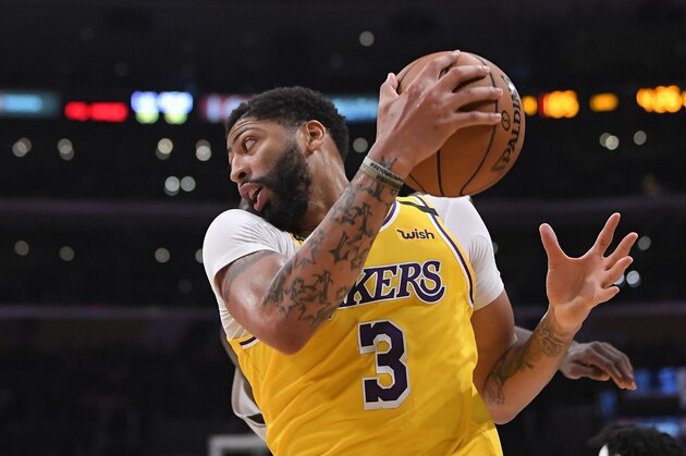 Los Angeles Lakers forward Anthony Davis drives toward the basket during the second half of an NBA basketball game against the Memphis Grizzlies Friday, Feb. 21, 2020, in Los Angeles. The Lakers won 117-105. (AP Photo/Mark J. Terrill)