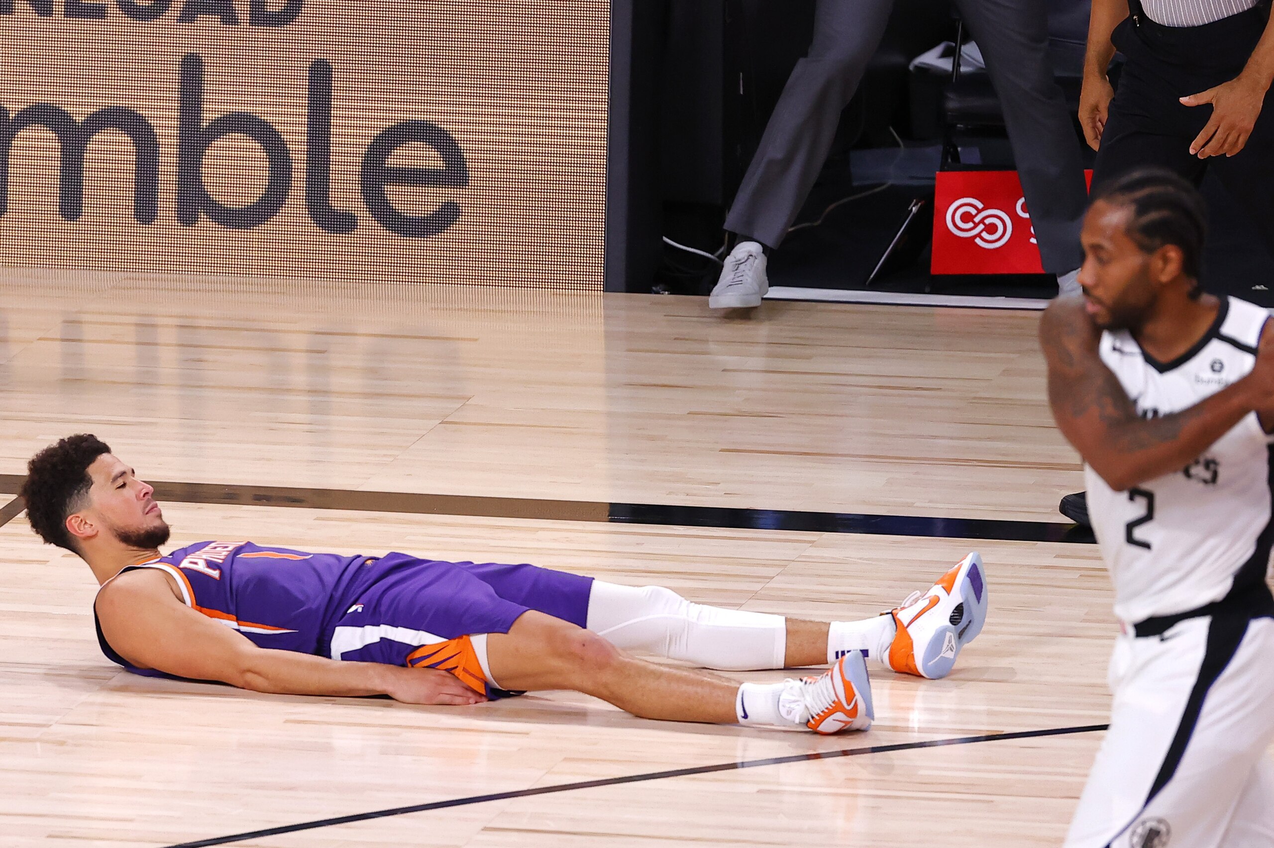 Phoenix Suns' Devin Booker falls to the ground after scoring the game-winning basket against the Los Angeles Clippers in an NBA basketball game Tuesday, Aug. 4, 2020, in Lake Buena Vista, Fla. (Kevin C. Cox/Pool Photo via AP) Phoenix Suns' Devin Booker falls to the ground after scoring the game-winning basket against the Los Angeles Clippers in an NBA basketball game Tuesday, Aug. 4, 2020, in Lake Buena Vista, Fla. (Kevin C. Cox/Pool Photo via AP)