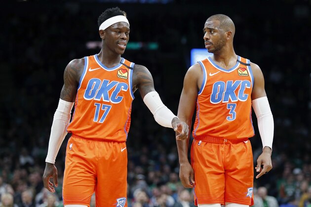 Oklahoma City Thunder's Dennis Schroder (17) and Chris Paul (3) platys against the Boston Celtics during the first half of an NBA basketball game, Sunday, March, 8, 2020, in Boston. (AP Photo/Michael Dwyer)