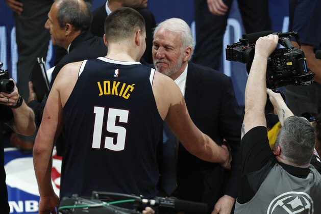 San Antonio Spurs head coach Gregg Popovich, right, congratulates Denver Nuggets center Nikola Jokic after Game 7 of an NBA basketball first-round playoff series, Saturday, April 27, 2019, in Denver. The Nuggets won 90-86 to advance to the second round against Portland. (AP Photo/David Zalubowski)