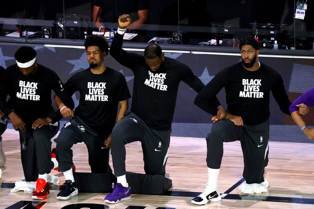 Los Angeles Lakers' LeBron James  kneels during the national anthem prior to the NBA basketball game against the Oklahoma City Thunder Wednesday, Aug. 5, 2020, in Lake Buena Vista, Fla. (Kevin C. Cox/Pool Photo via AP)