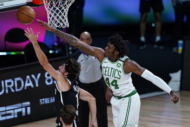 Boston Celtics center Robert Williams III (44) tries to block the shot of Brooklyn Nets forward Joe Harris (12) uring the first half of an NBA basketball game Wednesday, Aug. 5, 2020 in Lake Buena Vista, Fla. (AP Photo/Ashley Landis)