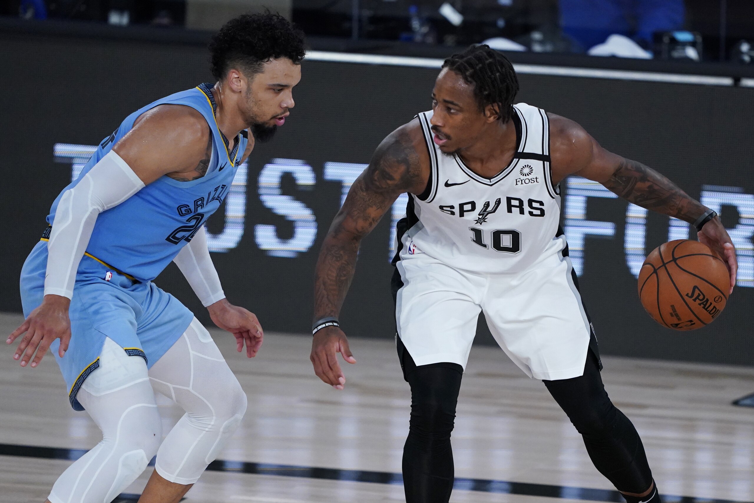 San Antonio Spurs' DeMar DeRozan (10) dribbles up the court against Memphis Grizzlies' Dillon Brooks (24) during the second half of an NBA basketball game Sunday, Aug. 2, 2020, in Lake Buena Vista, Fla. (AP Photo/Ashley Landis, Pool)